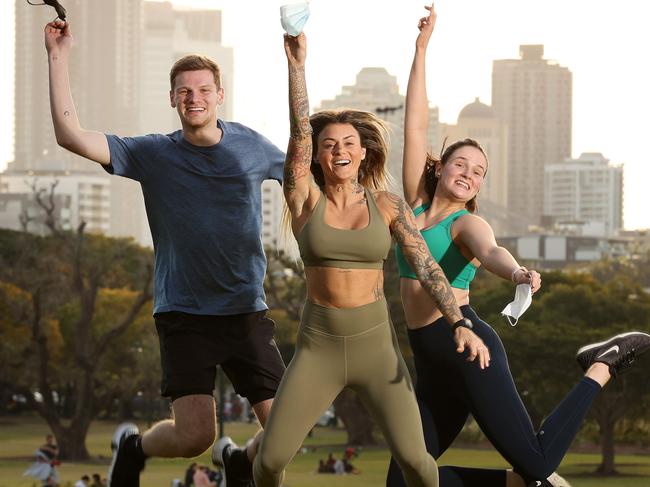 Alex Wicht, 21, Pullenvale, Marisa Mc Elroy, 32, Teneriffe, and Claire Wicht, 24, Toowong, celebrating the end of Covid lockdown, New Fram Park. Picture: Liam Kidston