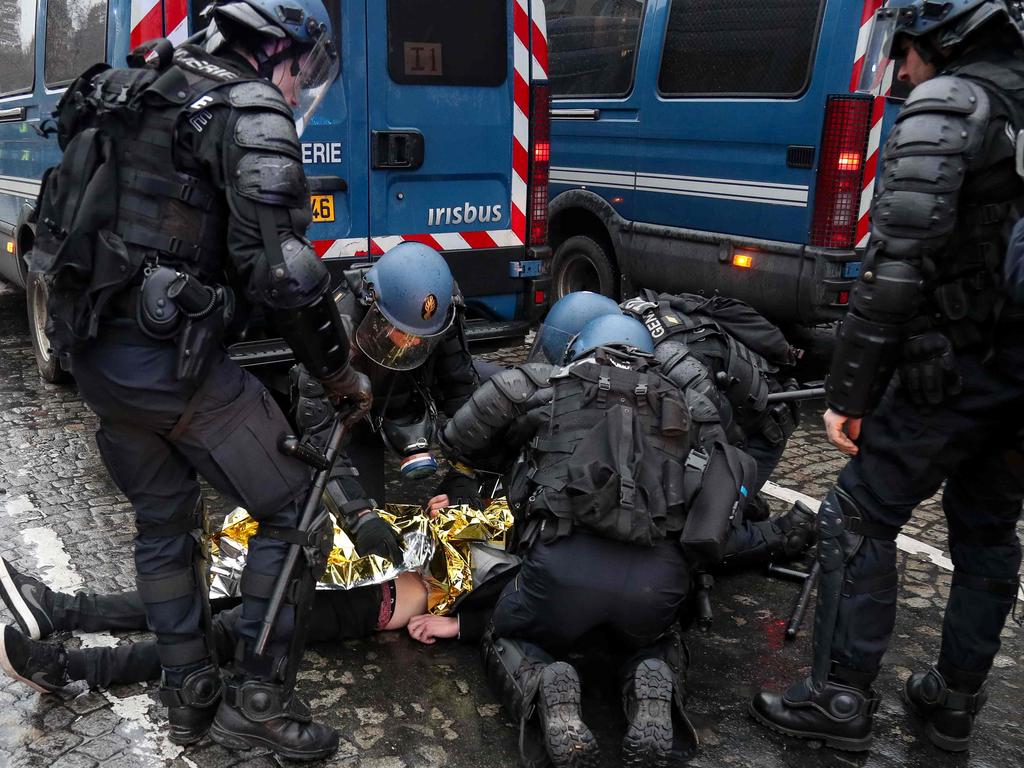 An injured man is helped by police forces. Picture: Zakaria Abdelkafi/AFP