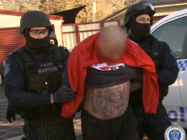 Strike Force Raptor officers arrest a man during a raid in Sackville in Sydney’s north. Picture: NSW Police