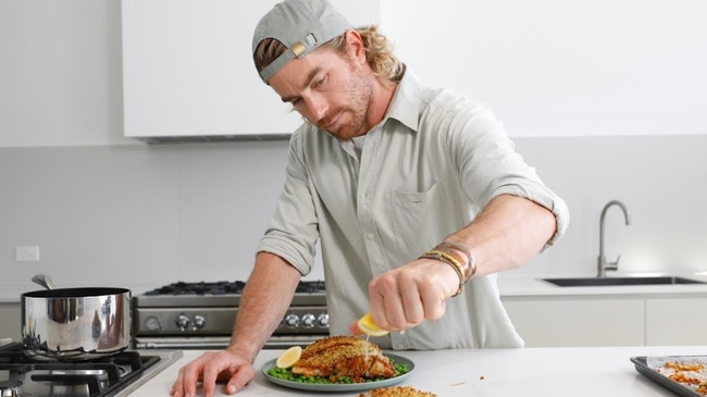 Former MasterChef Hayden Quinn cooks winter warmer dishes using only Woolies Own Brand products. Picture: Supplied