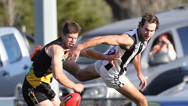 Morwell’s Brandon McDonald battles for the ball with a Sale opponent. Picture: Yuri Kouzmin