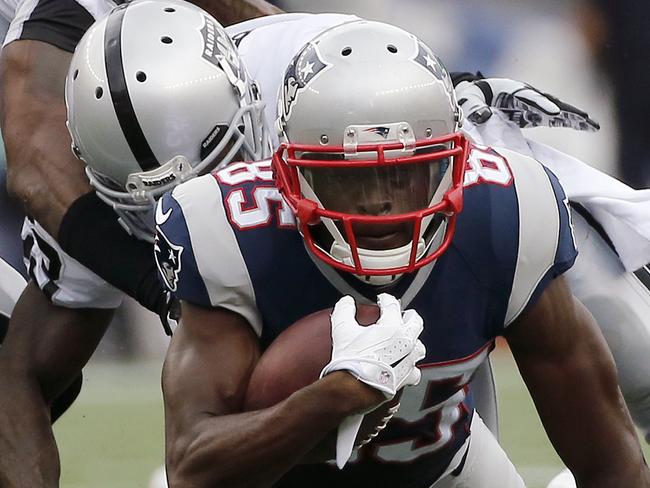 Oakland Raiders cornerback Tarell Brown, rear, tackles New England Patriots wide receiver Kenbrell Thompkins (85) after a catch in the second half of an NFL football game Sunday, Sept. 21, 2014, in Foxborough, Mass. (AP Photo/Elise Amendola)