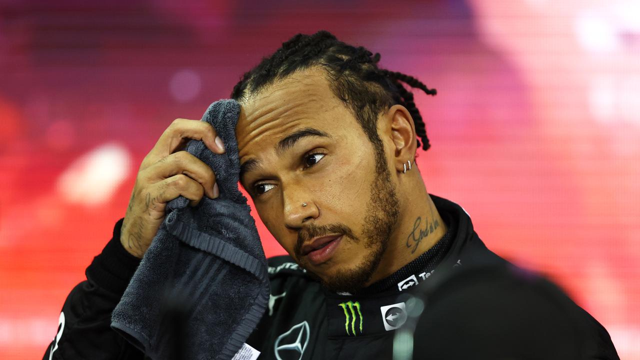 ABU DHABI, UNITED ARAB EMIRATES - DECEMBER 12: Second placed and championship runner up Lewis Hamilton of Great Britain and Mercedes GP looks dejected in parc ferme during the F1 Grand Prix of Abu Dhabi at Yas Marina Circuit on December 12, 2021 in Abu Dhabi, United Arab Emirates. (Photo by Bryn Lennon/Getty Images)