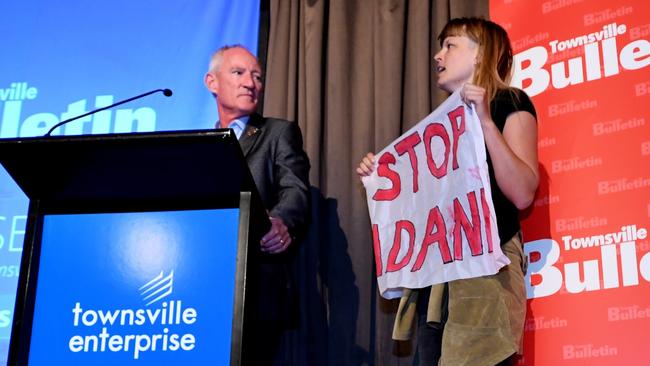 Anti-Adani protesters storm the stage as Pauline Hanson's One Nation Queensland Leader Steve Dickson (left) speaks at the Townsville Leaders forum. Picture: AAP/Tracy Nearmy