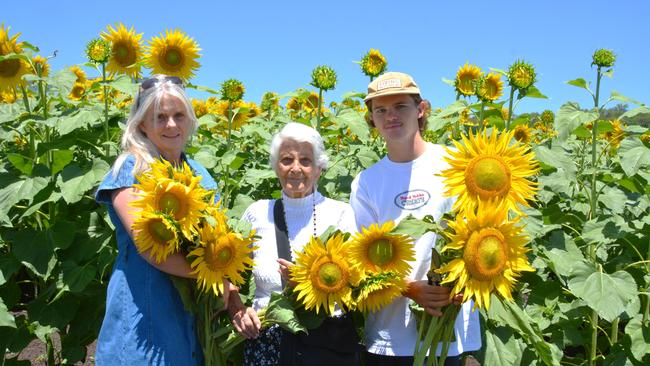 Lilyvale Flower Farm's impressive sunflower crop saw dozens flock to the sunny fields, including (from left) Sue Edwards, Lotte Schubert and Harrison Edwards on Sunday, December 22, 2024. Photo: Jessica Klein