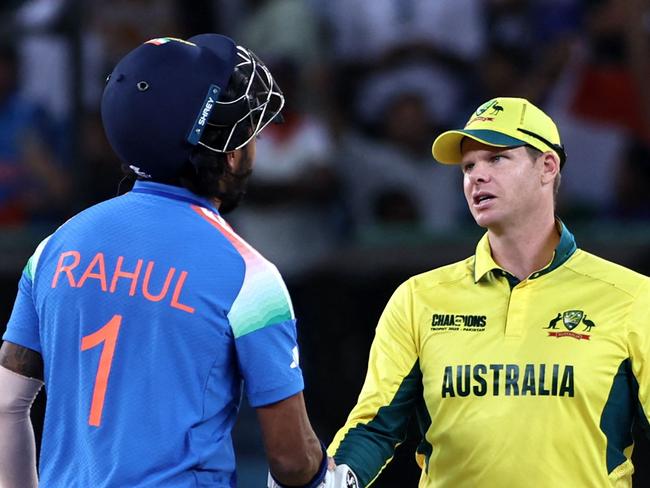 Australia's captain Steve Smith (C) shakes hands with India's KL Rahul as India's Ravindra Jadeja (R) watches at the end of the ICC Champions Trophy one-day international (ODI) semi-final cricket match between Australia and India at the Dubai International Stadium in Dubai on March 4, 2025. (Photo by FADEL SENNA / AFP)