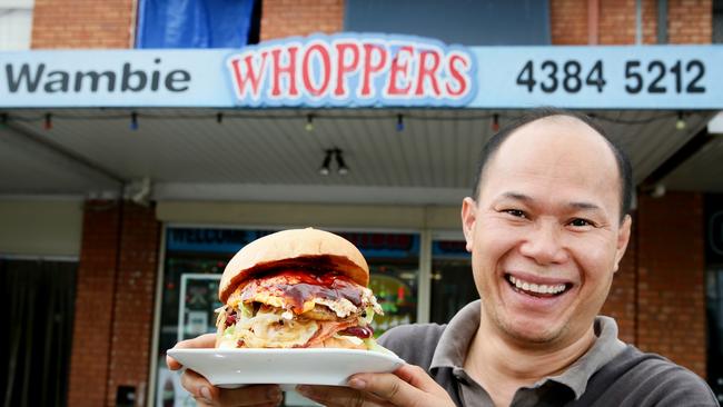 Eric Phu Soksan with his Wambie Whopper burger at Wamberal. The court heard he did not read English language newspapers. Picture: Peter Clark