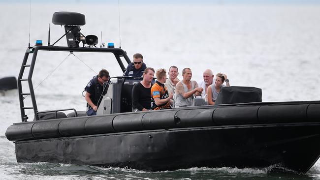 Passengers return to Manly boat Habour aboard a Queensland Water Police boat after the charterboat they were on this morning capsized in Moreton Bay.