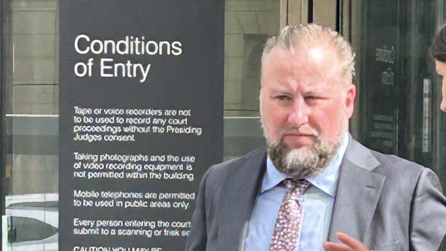 Rail Projects Victoria Metro Tunnel's creative strategy lead Luke Diggins outside County Court after being released on a recognizance release order.