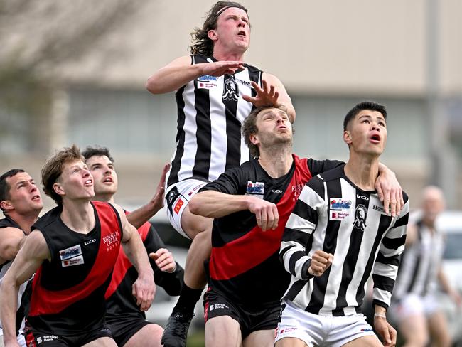 WallanÃs Patrick Mahoney flys over players during the ERDFNL Riddell v Wallan Qualifying 2 football match in Romsey, Saturday, Aug. 31, 2024. Picture: Andy Brownbill