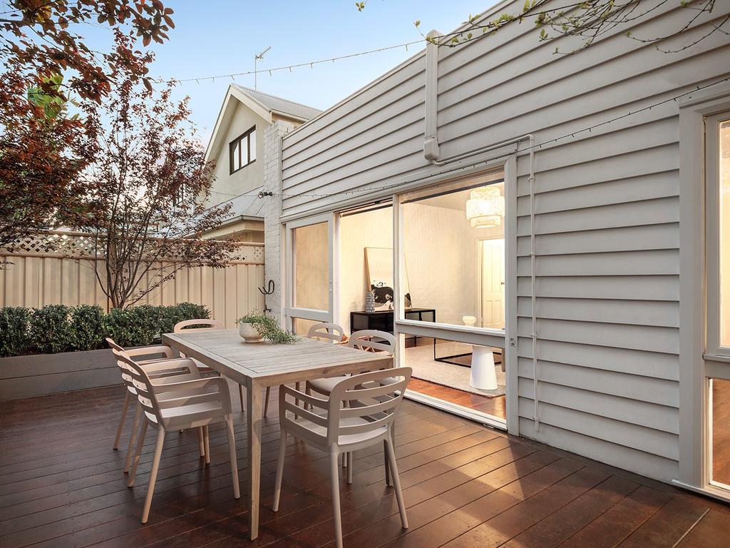The back yard has a deck.