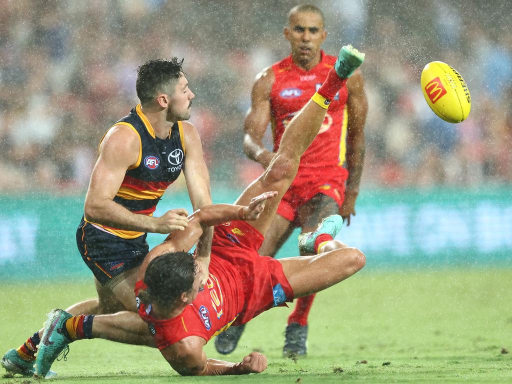 Tom Berry gets a kick away on a wet night against the Crows. Picture: Chris Hyde/Getty Images