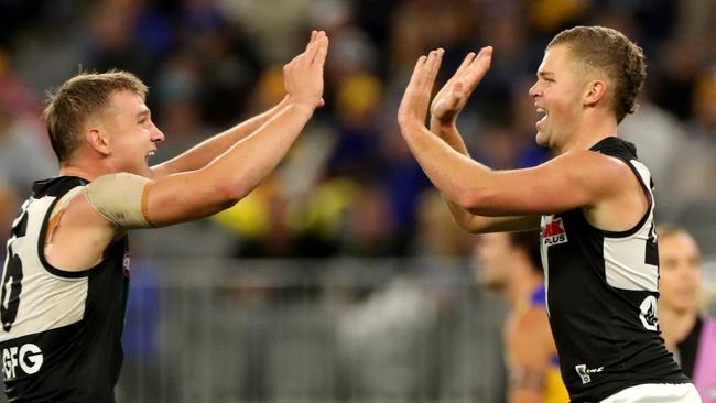 Dan Houston, right, of the Power is congratulated by Ollie Wines after kicking a goal against the West Coast Eagles. Picture: AAP Image/Richard Wainwright