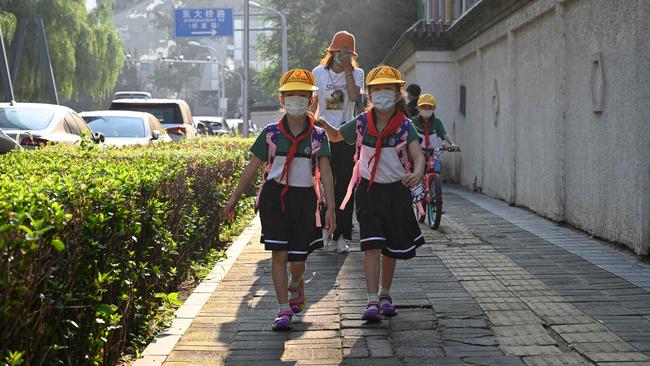 Primary school students arrive for the first day of the new term in Beijing on Wednesday. Picture: AFP