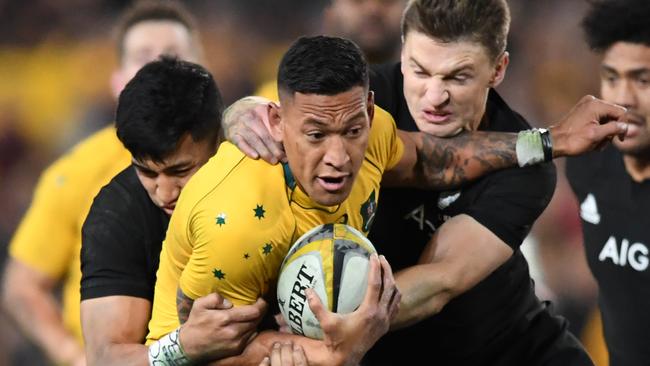 Folau of Australia is tackled by Rieko Ioane and Beauden Barrett. (AAP Image/David Moir)