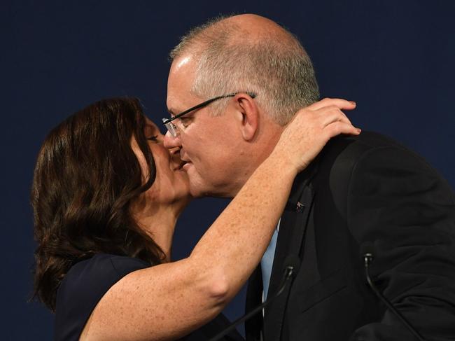 Enduring love story... Scott Morrison kisses wife Jenny after his victory speech. Picture: AFP