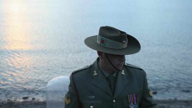 ECEABAT, TURKEY - APRIL 22: Corporal Andrew Barnett of the Australian Army Band, who will play the bugle at the upcoming Dawn Service commemoration ceremony to honour Australian and New Zealand soldiers killed in the Gallipoli Campaign, stands at Anzac Cove on April 22, 2015 near Eceabat, Turkey. Allied and Turkish representatives, as well as family members of those who served, will commemorate the 100th anniversary of the campaign with ceremonies scheduled for April 24-25. The Gallipoli land campaign, in which a combined Allied force of British, French, Australian, New Zealand and Indian troops sought to occupy the Gallipoli peninsula and the strategic Dardanelles strait during World War I, began on April 25, 1915 against Turkish forces of the Ottoman Empire. The Allies, unable to advance more than a few kilometers, withdrew after eight months. The campaign cost the Allies approximately 45,000 killed and up to 200,000 wounded, the Ottomans approximately 85,000 killed and 160,000 wounded. (Photo by Sean Gallup/Getty Images) *** BESTPIX ***