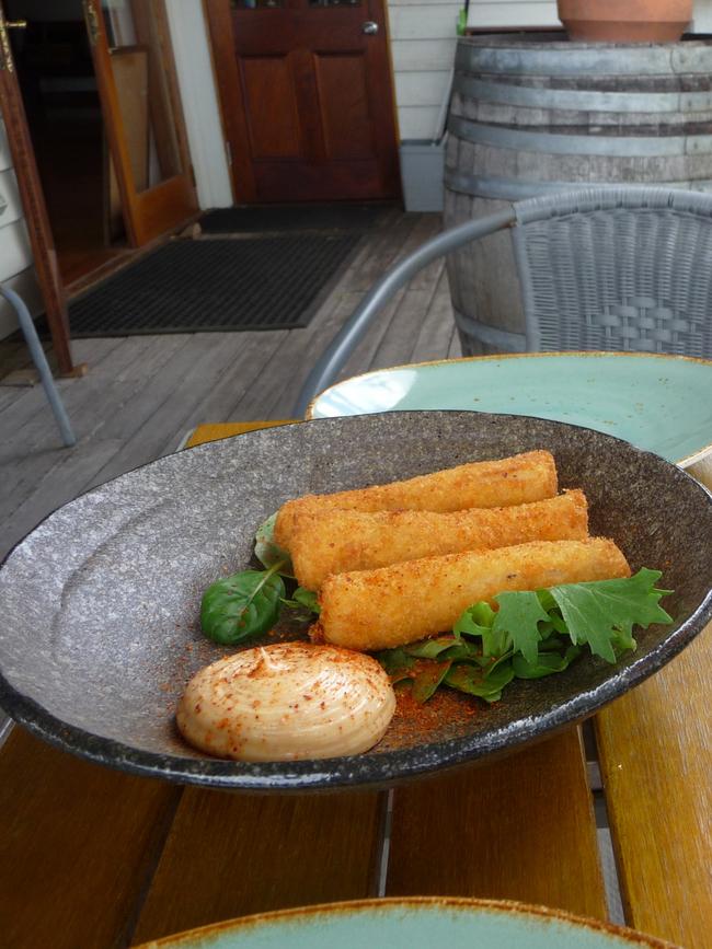 The cheese and proscuitto croquettes with a glass of Milton rose. Picture: LIBBY SUTHERLAND