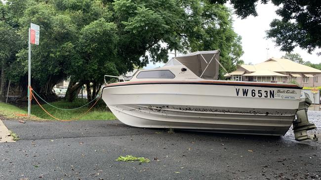 A boat was left stricken on Laurel Avenue as flood water receded on Tuesday.