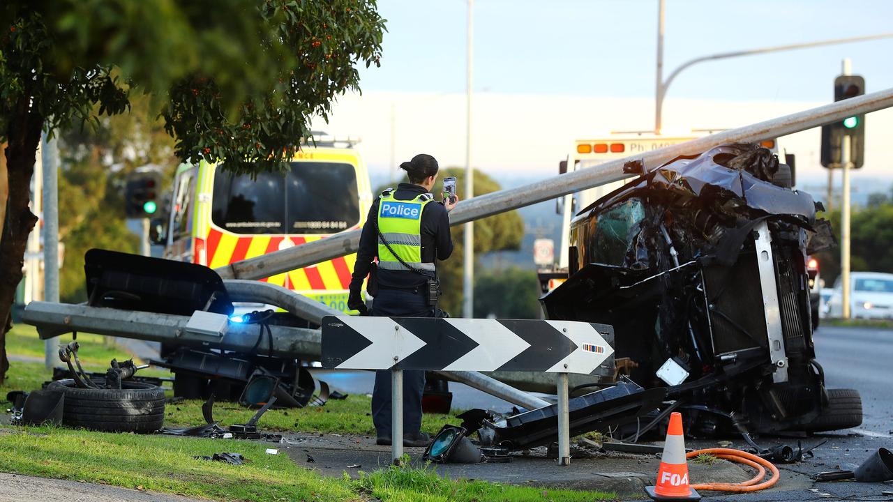 A black BMW smashed into a light pole on the Bellarine Hwy. Picture: Alison Wynd