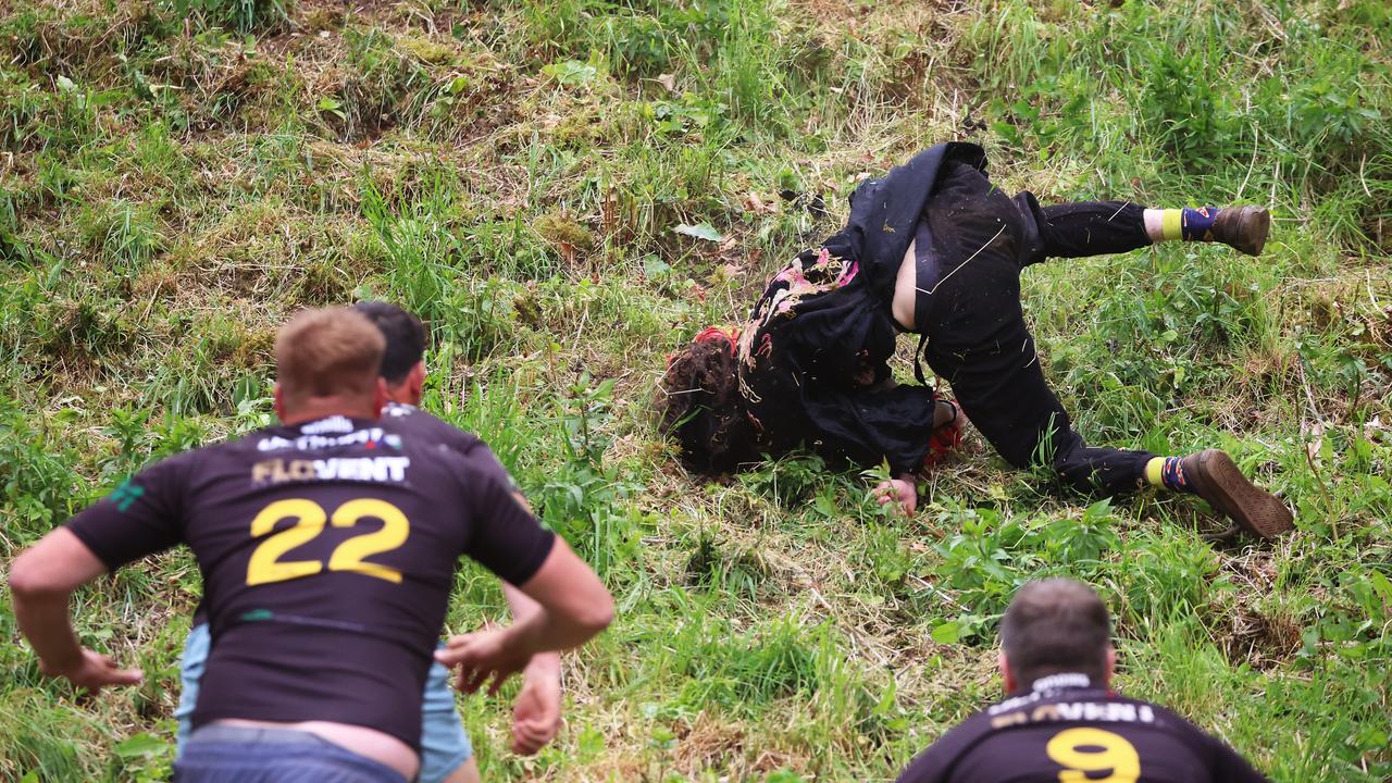 A person takes a fall following Gloucestershire's famous Cheese-Rolling contest on May 26. Picture: Cameron Smith/Getty Images