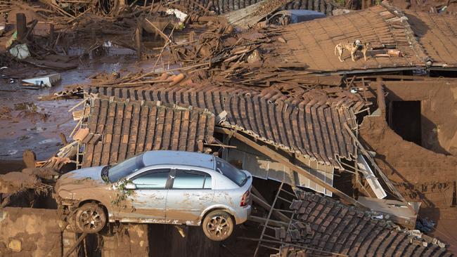 A car on the roof of destroyed houses in Bento Rodrigues after a dam burst in Minas Gerais state, Brazil