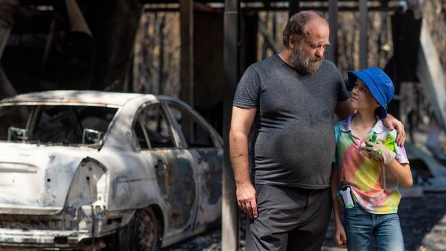 Ken Rowley and son Connor Rowley, 12 are thankful they are safe after a fire ripped through their family home on Sunday, destroying a shed, car and cool room. Picture: Che Chorley