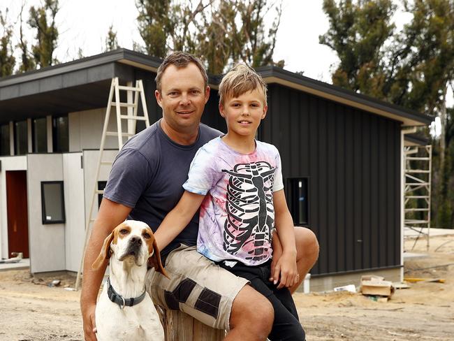 Arlo Ireland and son Harper in front of their newly built home. Picture: Sam Ruttyn