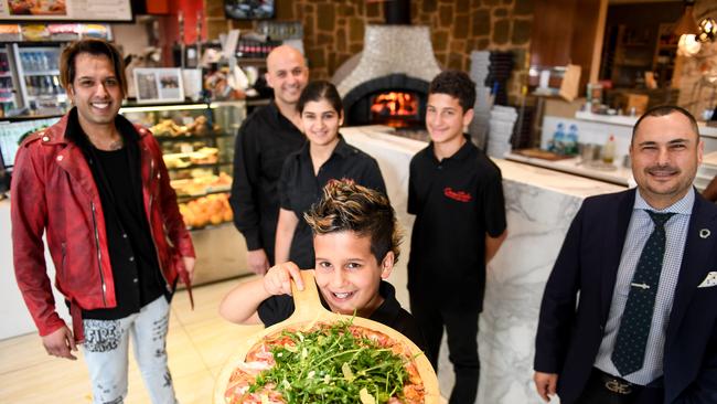 Cucina Dolce owner and best cafe Moorabbin/ Mordialloc Chelsea winner Freddy Kerbage (back) with wife Inas and sons Maurice and Zane (front). Last year they teamed up with hair stylist Deen Mos (L) and O’Brien Real Estate Chelsea director Stavros Ambatzidis to deliver free food to people who struggled during lockdown. Picture: Penny Stephens