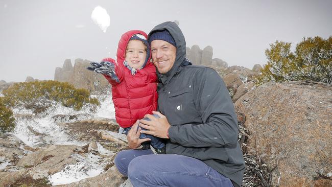 Matt Bailey, from Western Australia, took his son Louie, 3, to kunanyi/Mt Wellington to experience snow for the first time. Picture: PATRICK GEE