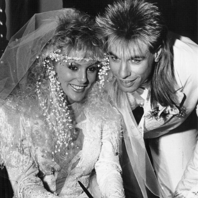 Warwick Capper and former wife Joanne sign the register at the Uniting Church in Collins Street, Melbourne after their wedding in 1988.
