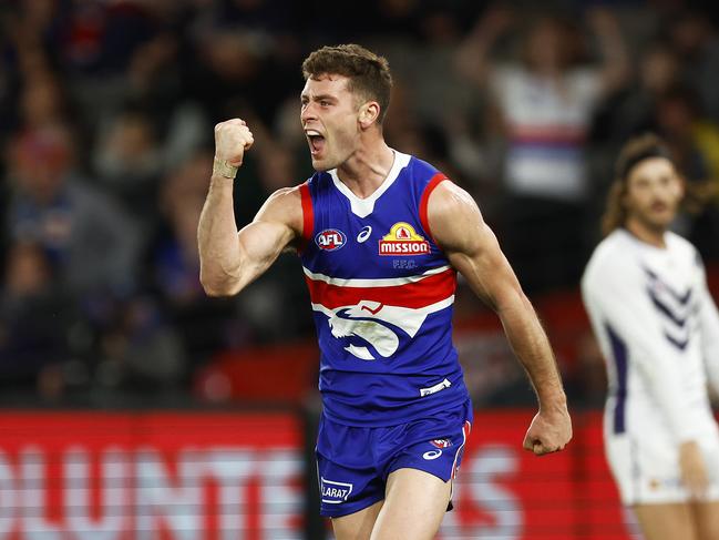 MELBOURNE, AUSTRALIA - AUGUST 06: Josh Dunkley of the Bulldogs celebrates kicking a goal during the round 21 AFL match between the Western Bulldogs and the Fremantle Dockers at Marvel Stadium on August 06, 2022 in Melbourne, Australia. (Photo by Daniel Pockett/Getty Images)