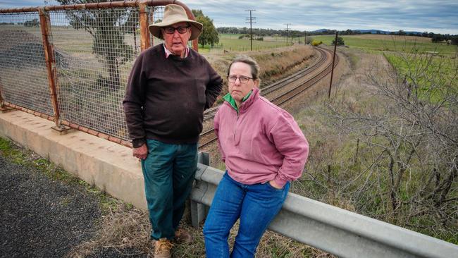 Eric and Yvette McKenzie near where the proposed railway line will cross their property. Picture: Brad Newman