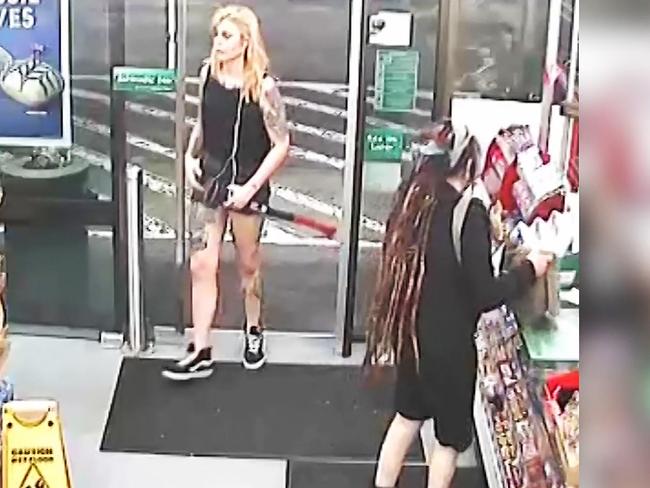 Evie Amati enters Enmore 7-Eleven armed with an axe and a knife, walking by Sharon Hacker at the till.