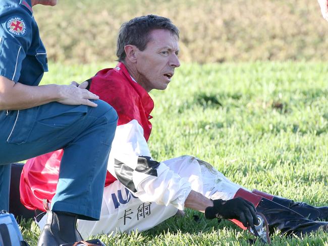 Jockey Michael Cahill is attended to after coming off Artlee. Picture: Jono Searle