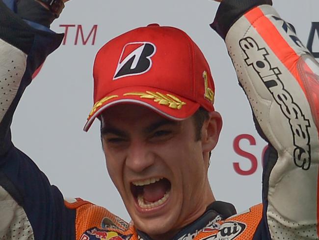 Repsol Honda Team's Spanish rider Dani Pedrosa celebrates on the podium after winning the Malaysian Grand Prix MotoGP motorcycling race at the Sepang International Circuit on October 25, 2015. AFP PHOTO / MOHD RASFAN