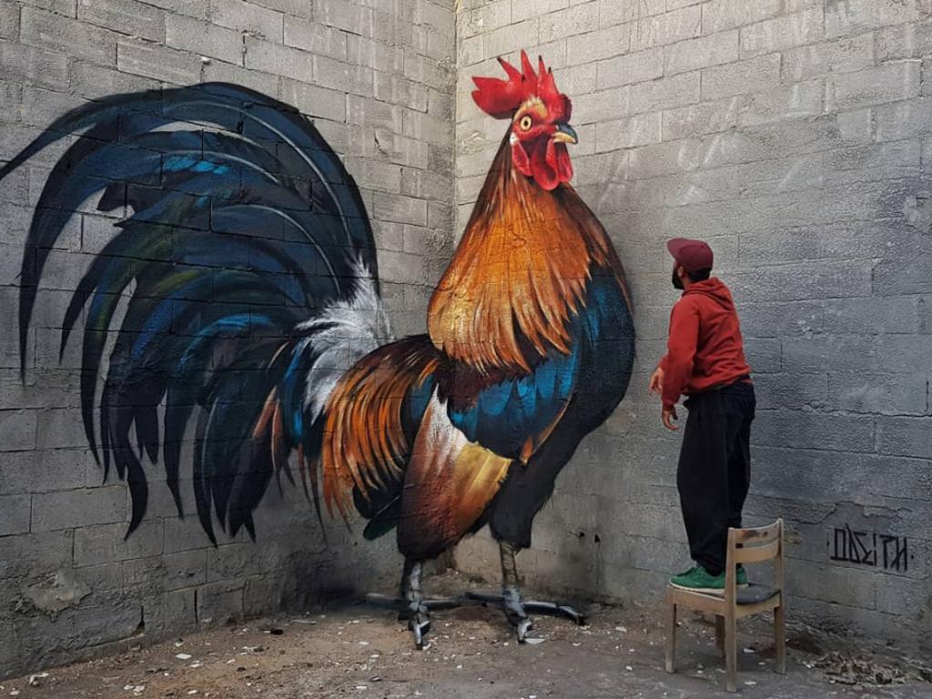 Odeith talking to the painted rooster. Picture: Odeith/Instagram