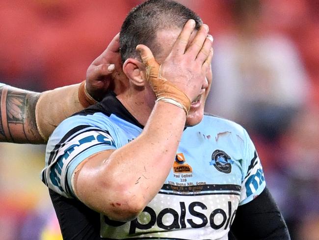 Andrew Fifita and Paul Gallen of the Sharks react at full time after losing in his 300th NRL game in the round 23 NRL match between the Brisbane Broncos and the Cronulla Sharks played at Suncorp Stadium in Brisbane, Friday, August 11, 2017. (AAP Image/Darren England) NO ARCHIVING, EDITORIAL USE ONLY