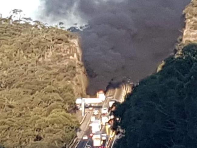 Thick black smoke billowed high into the sky from the crash scene. Picture: NSW Rural Fire Service