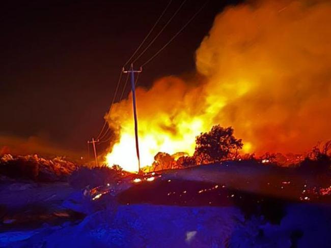 A bushfire burns close to powerlines in Western Australia's wheatbelt. Picture: Supplied/ Gingin West Volunteer Bush Fire Brigade