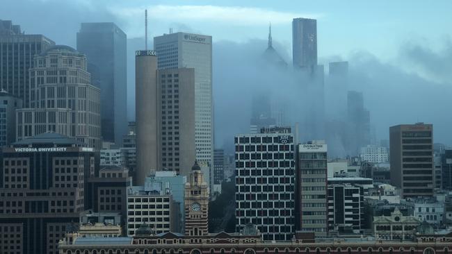 Smoke haze around the city’s skyscrapers on Monday morning. Smoke is still lingering in the eastern suburbs on Tuesday.