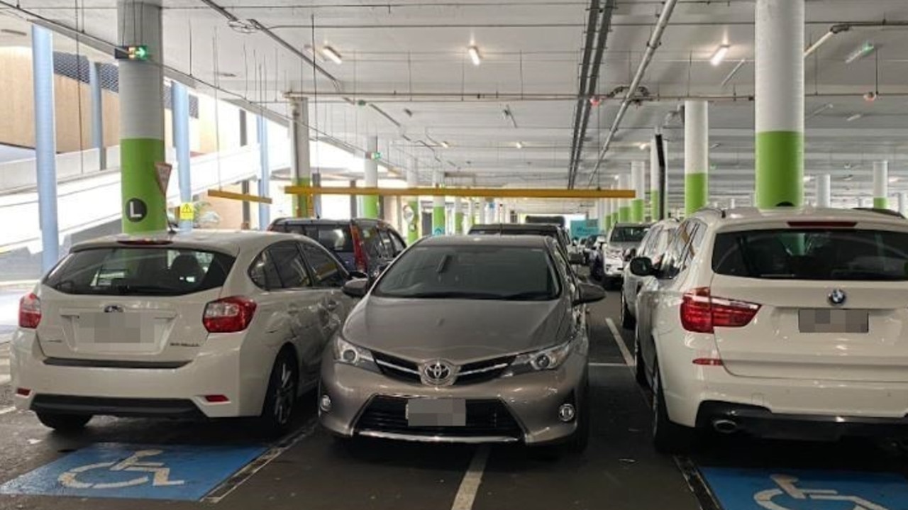 This driver was slammed online for parking between two cars parked in disabled bays in Westfield Eastgardens, Sydney. Picture: Facebook