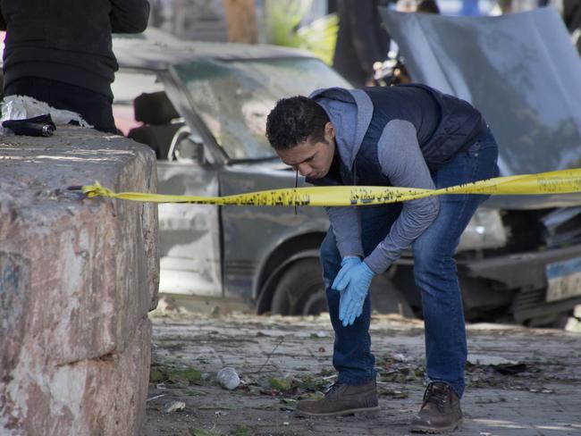 An Egyptian explosives expert looks for evidence at the site of a bomb explosion in Cairo, Egypt. Picture: AP