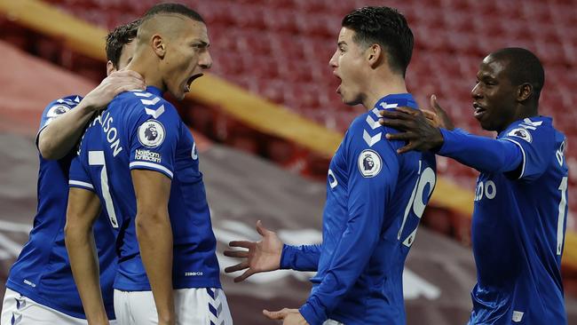 Everton’s Richarlison, left, celebrates with teammates after scoring against Liverpool