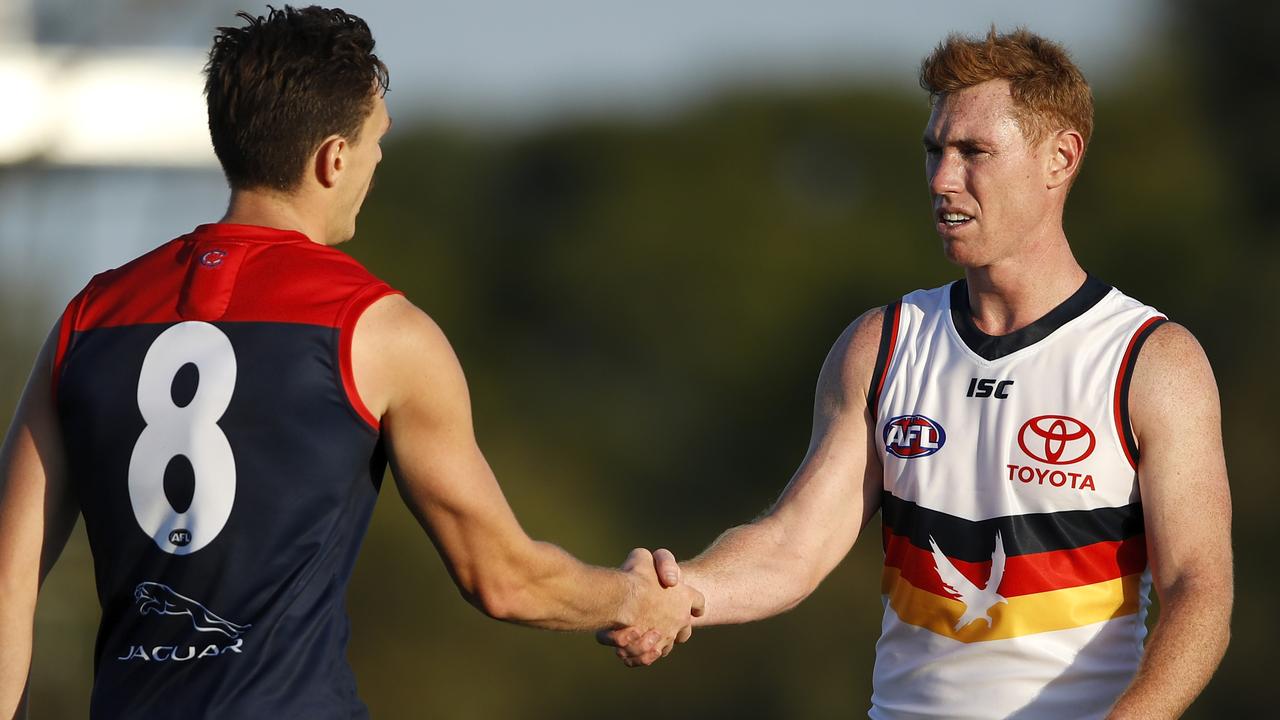 Tom Lynch shakes hands with his former teammate Jake Lever after Saturday’s pre-season clash. Picture: Dylan Burns (Getty).