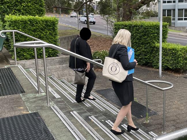 The woman, left, leaves court with her defence lawyer. Picture: Fiona Killman