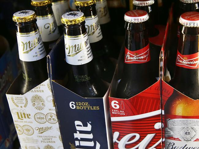 MIAMI, FL - SEPTEMBER 16: In this photo illustration, bottles of Budweiser and Miller Lite beer are seen on September 16, 2015 in Miami, Florida. Belgium's Anheuser-Busch InBev, which owns Budweiser and is the worlds largest brewer, is reported to be in takeover talks for the number two positioned British-based SABMiller, owner the Miller beers. (Photo Illustration by Joe Raedle/Getty Images/AFP == FOR NEWSPAPERS, INTERNET, TELCOS & TELEVISION USE ONLY ==