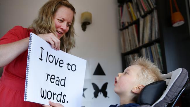 Ina teaching Roki Mills to read., He was born with brain damage,