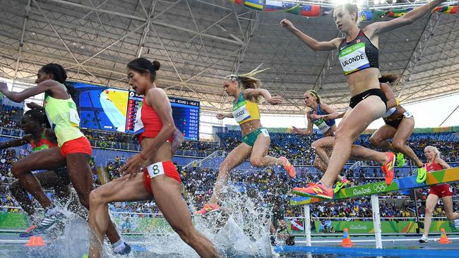 TOPSHOT — Australia's Genevieve LaCaze (C) and Canada's Genevive Lalonde (R) compete in the Women's 3000m Steeplechase Round 1 during the athletics event at the Rio 2016 Olympic Games at the Olympic Stadium in Rio de Janeiro on August 13, 2016. / AFP PHOTO / FRANCK FIFE