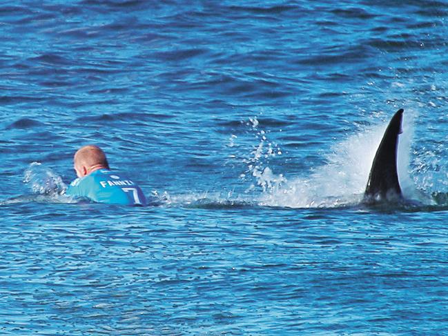 RGB.. This handout screengrab made and released on July 19, 2015 by the Worl Surf League (WSL) shows Australian surfer Mick Fanning being attacked by a shark during the Final of the JBay surf Open on Sunday July 19, 2015 in Jeffreys Bay. Mick Fanning, 34, was competing in the final heat of a world tour event at Jeffreys Bay in the country's Eastern Cape province when a looming black fin appeared in the water behind him. He fought back against the shark, escaping from the terrifying scene without injury. AFP PHOTO / WSL ==RESTRICTED TO EDITORIAL USE - MANDATORY CREDIT "AFP PHOTO / WSL" - NO MARKETING - NO ADVERTISING CAMPAIGNS - DISTRIBUTED AS A SERVICE TO CLIENTS==